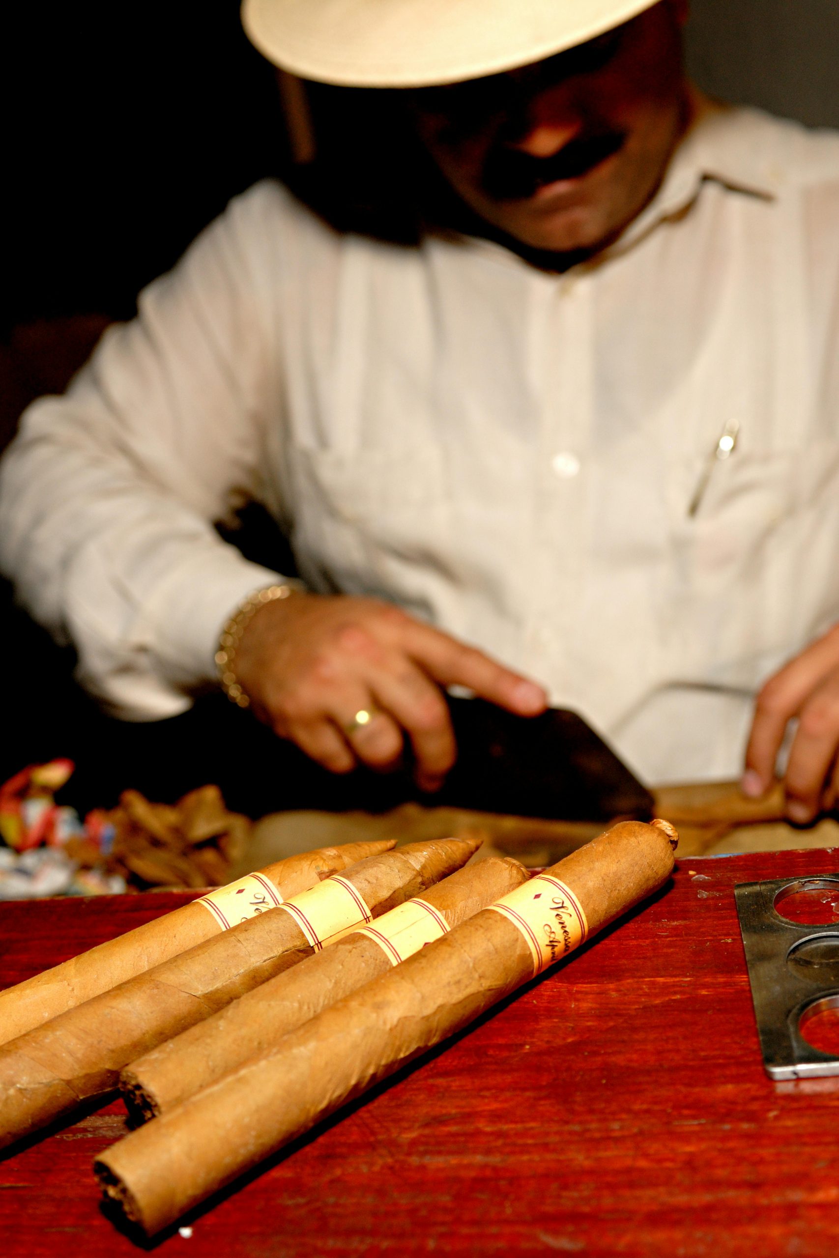 A skilled artisan rolls fine Cuban cigars by hand, showcasing Havana's rich tradition.